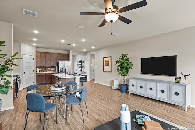 dining space featuring ceiling fan and light hardwood / wood-style floors