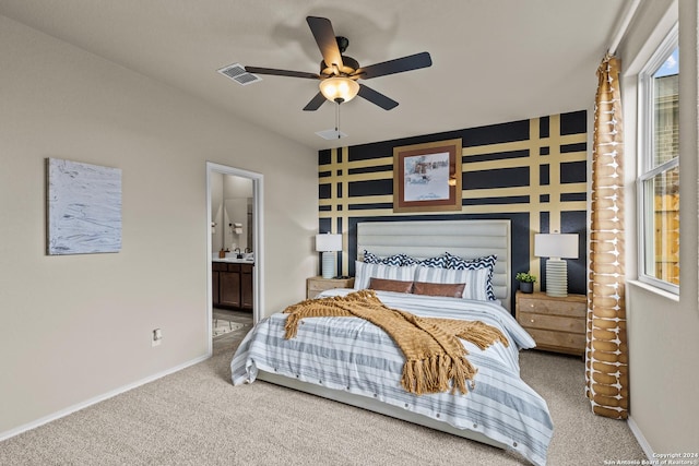 carpeted bedroom featuring connected bathroom and ceiling fan