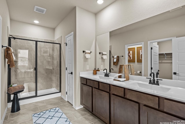 bathroom with vanity and a shower with shower door