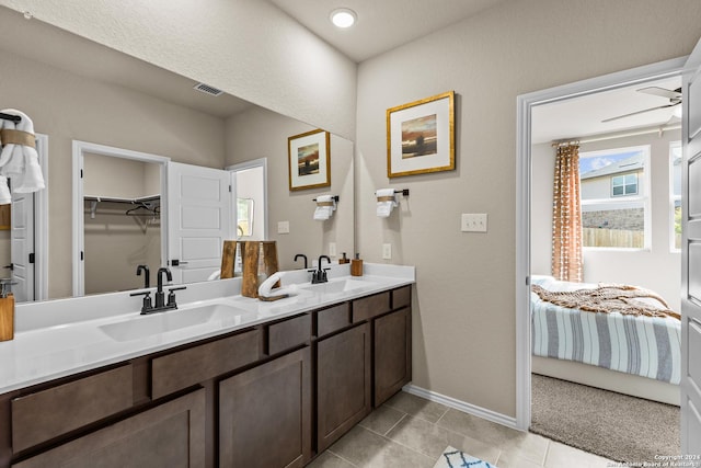 bathroom with tile patterned flooring, vanity, and ceiling fan