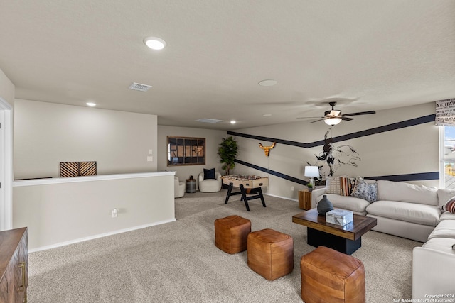 carpeted living room with a textured ceiling and ceiling fan