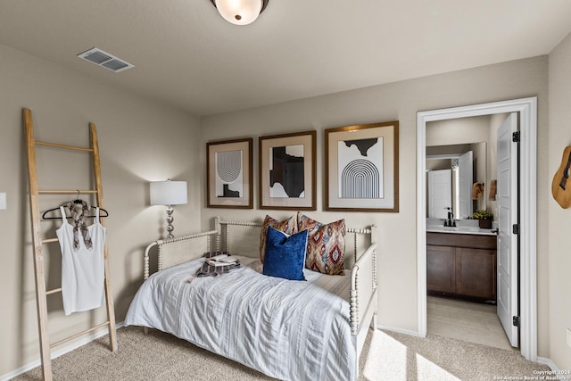 carpeted bedroom featuring ensuite bathroom