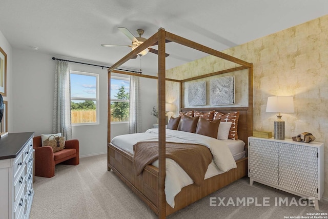 bedroom featuring light carpet and ceiling fan