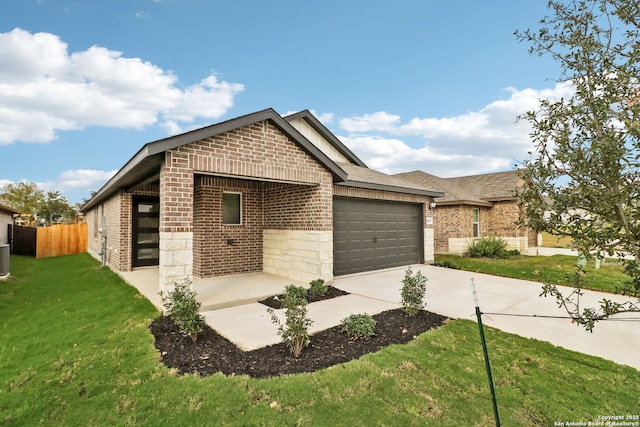 view of front of home with a garage and a front lawn