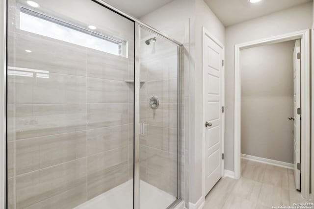 bathroom with a shower with shower door