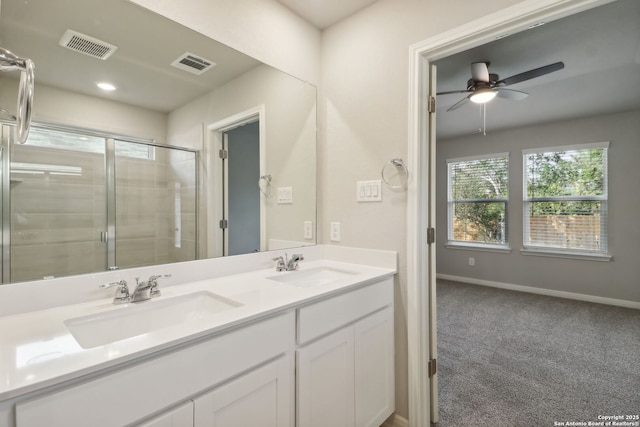 bathroom with vanity, an enclosed shower, and ceiling fan