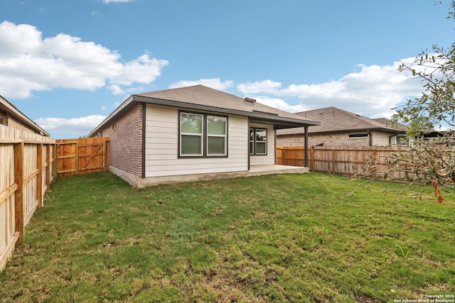 back of house featuring a yard