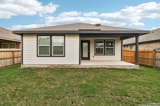 rear view of house with a yard and a patio area