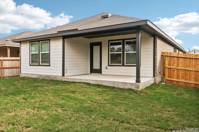 back of property featuring a patio and a yard