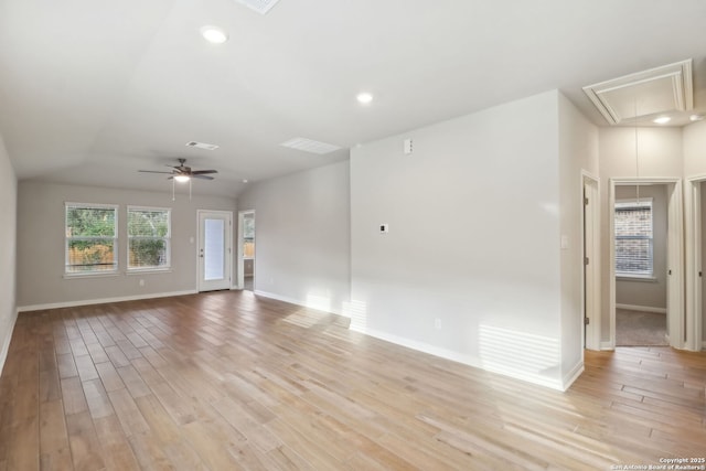 empty room with ceiling fan and light hardwood / wood-style flooring