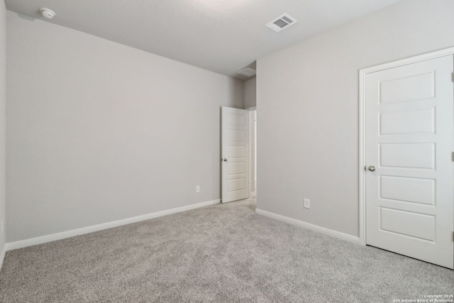 unfurnished bedroom with carpet flooring and baseboards