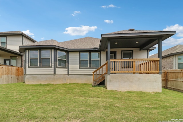 back of property with a shingled roof