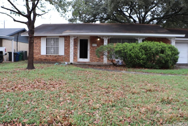 ranch-style home with a garage and a front yard