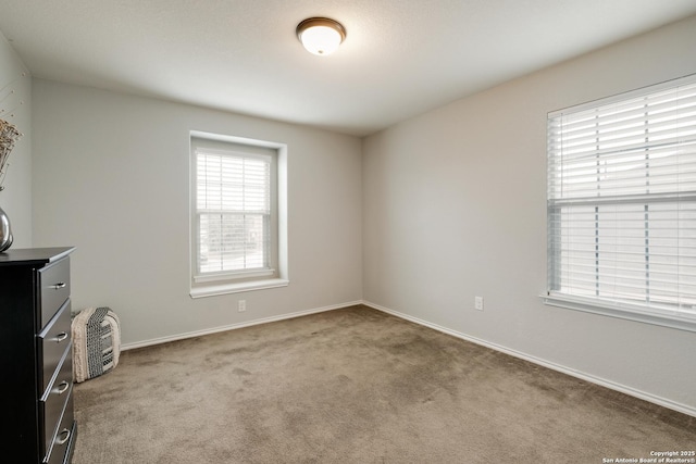 unfurnished room featuring light colored carpet