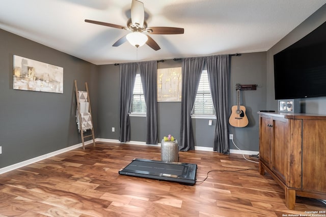 workout area featuring ceiling fan and wood-type flooring