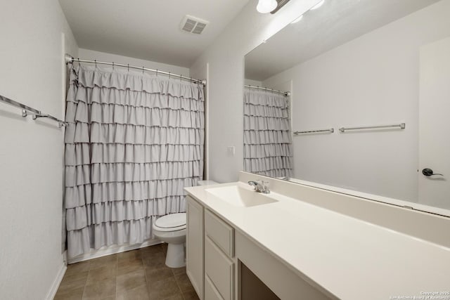 bathroom featuring vanity, toilet, and walk in shower