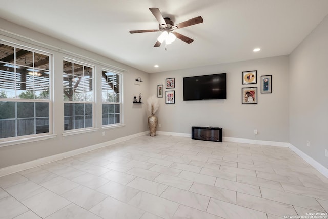 unfurnished living room with ceiling fan