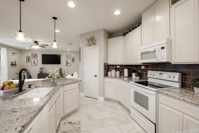 kitchen featuring white cabinetry, sink, white appliances, and decorative light fixtures