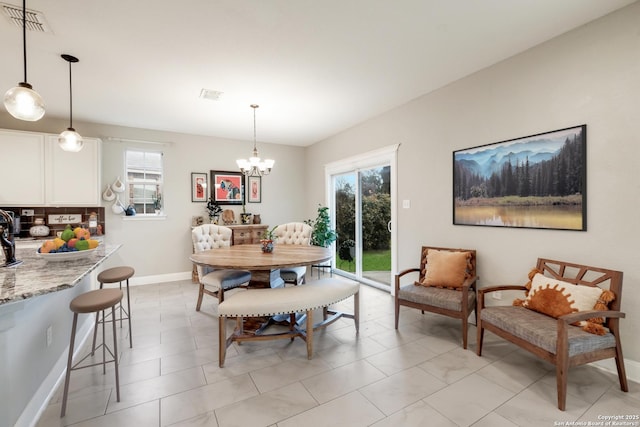 dining area featuring a wealth of natural light and a chandelier