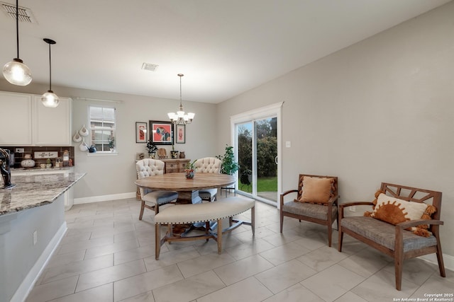 dining space with a chandelier and a healthy amount of sunlight