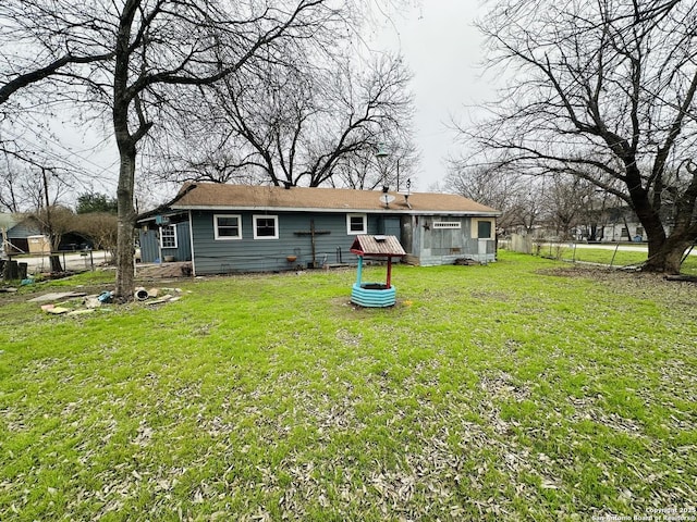 rear view of house with a yard