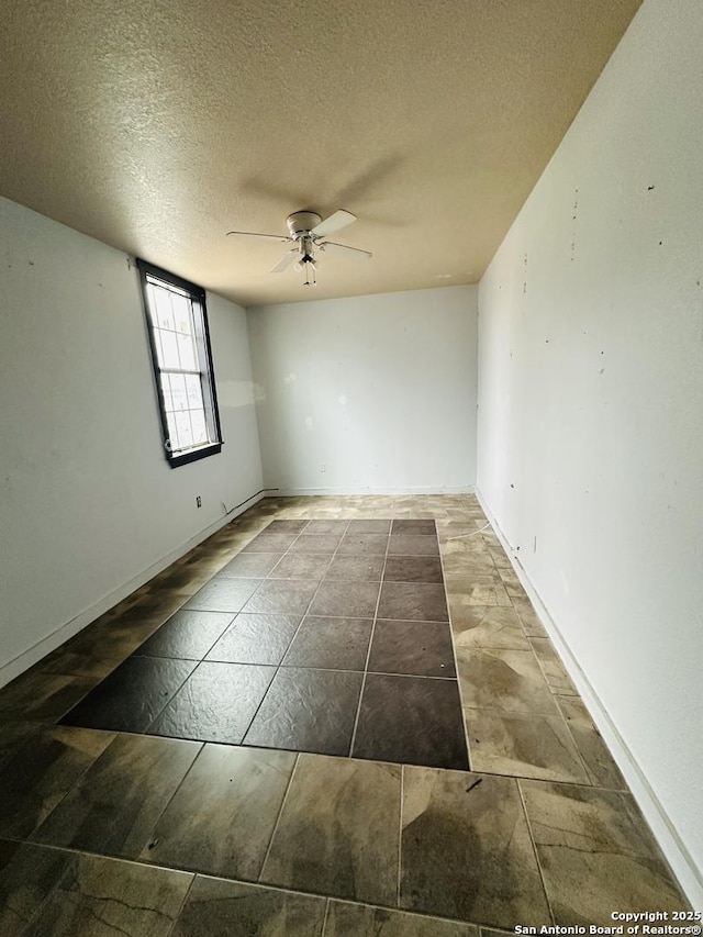 spare room featuring a textured ceiling and ceiling fan