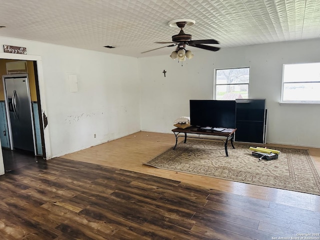 sitting room with hardwood / wood-style flooring and ceiling fan