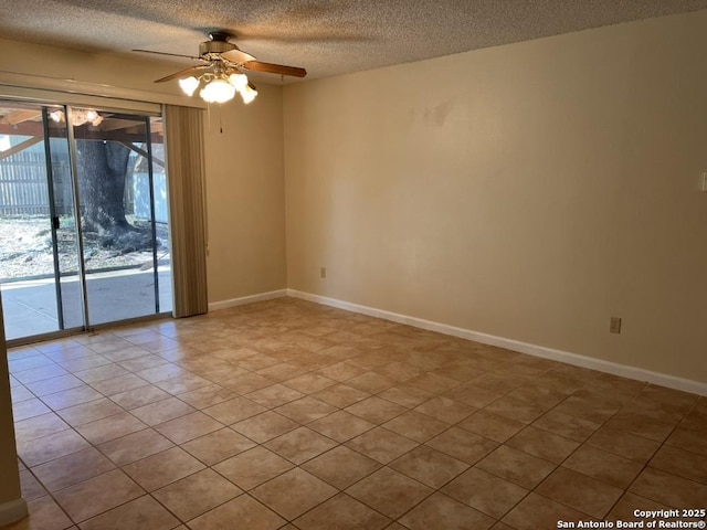 unfurnished room with ceiling fan and a textured ceiling