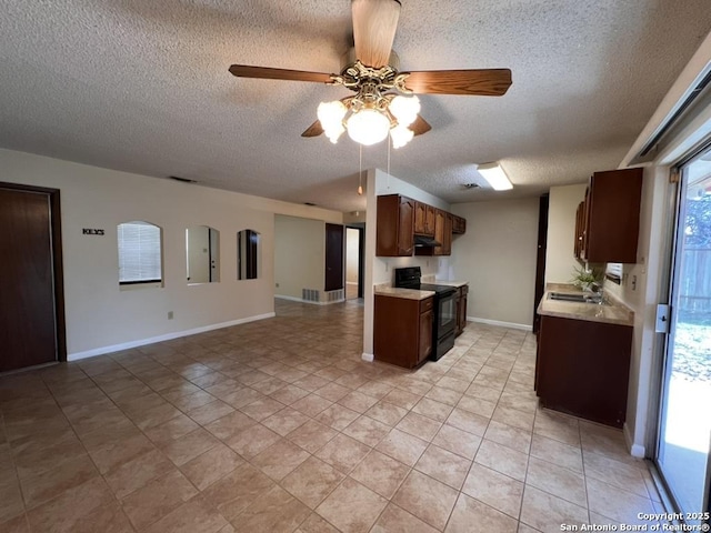 kitchen featuring light tile patterned floors, sink, a textured ceiling, ceiling fan, and black / electric stove