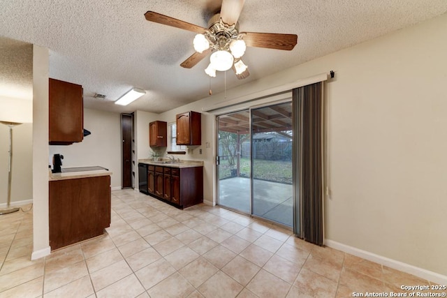 kitchen with ceiling fan, light tile patterned floors, sink, and black dishwasher