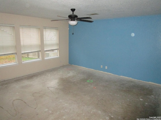 unfurnished room featuring concrete flooring and a textured ceiling