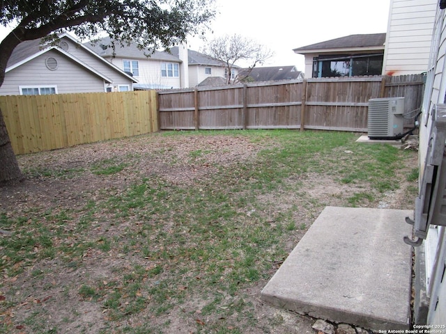 view of yard with cooling unit and a patio area