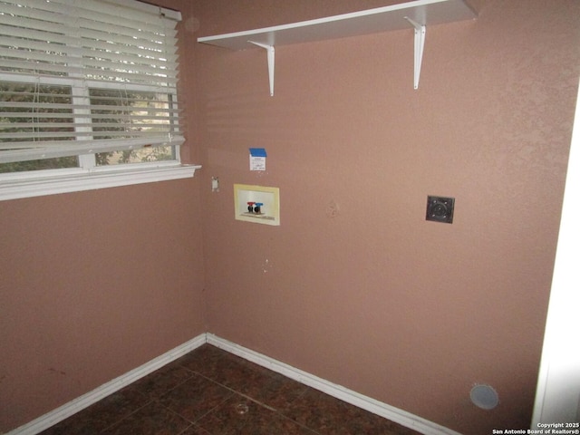 laundry room with hookup for a washing machine, hookup for an electric dryer, and dark tile patterned flooring