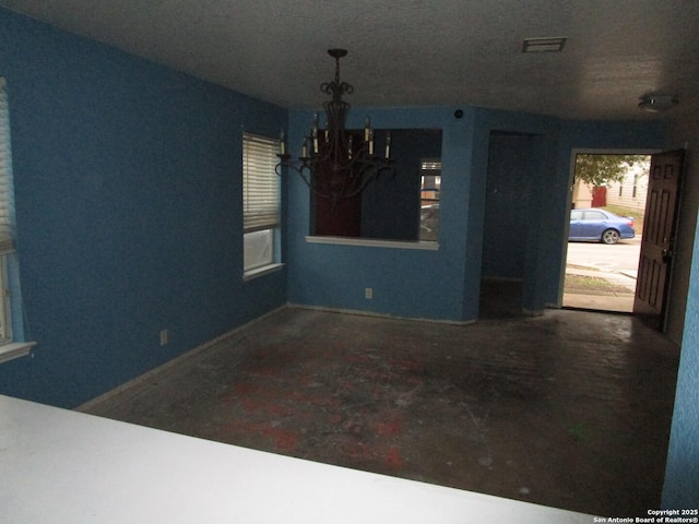 unfurnished dining area with a chandelier