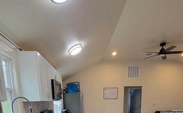 39 Post Oak Ln, Vernia, TX 78121 - details featuring white cabinetry, sink, stainless steel fridge, ceiling fan, and a textured ceiling