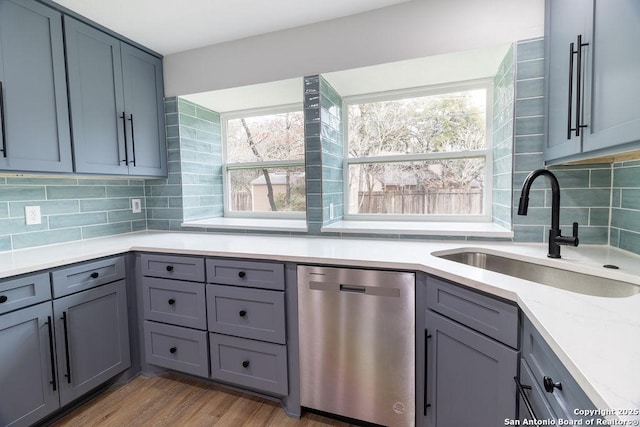 kitchen featuring dishwasher, plenty of natural light, sink, and light hardwood / wood-style floors