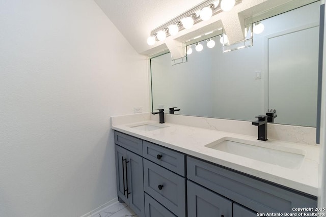 bathroom featuring vanity and a textured ceiling