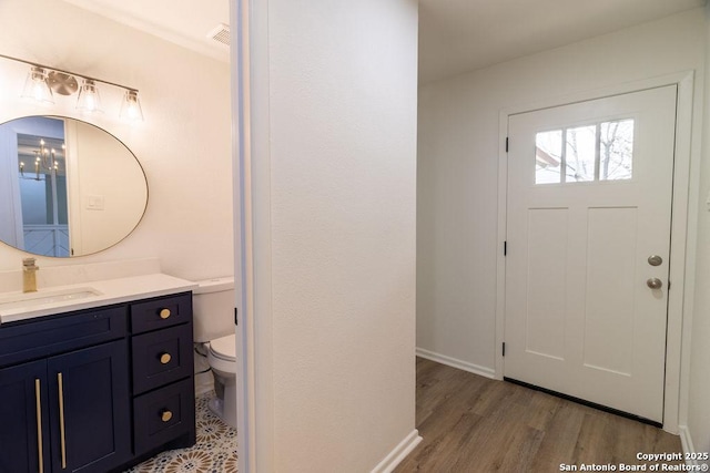 bathroom featuring vanity, hardwood / wood-style floors, and toilet