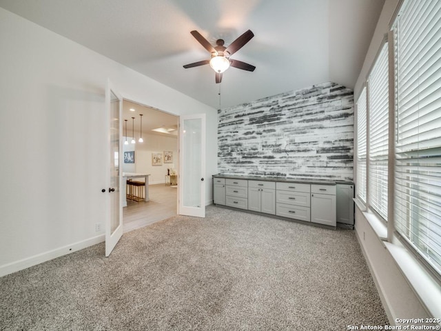 unfurnished bedroom with light colored carpet, french doors, and ceiling fan