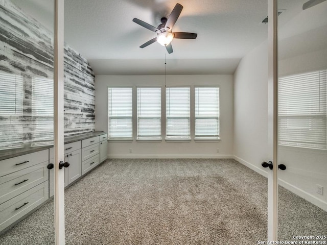 interior space featuring vaulted ceiling and ceiling fan