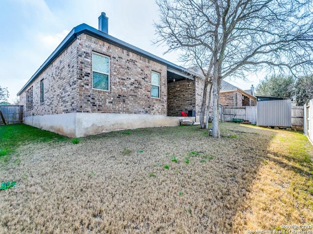 rear view of house with a yard