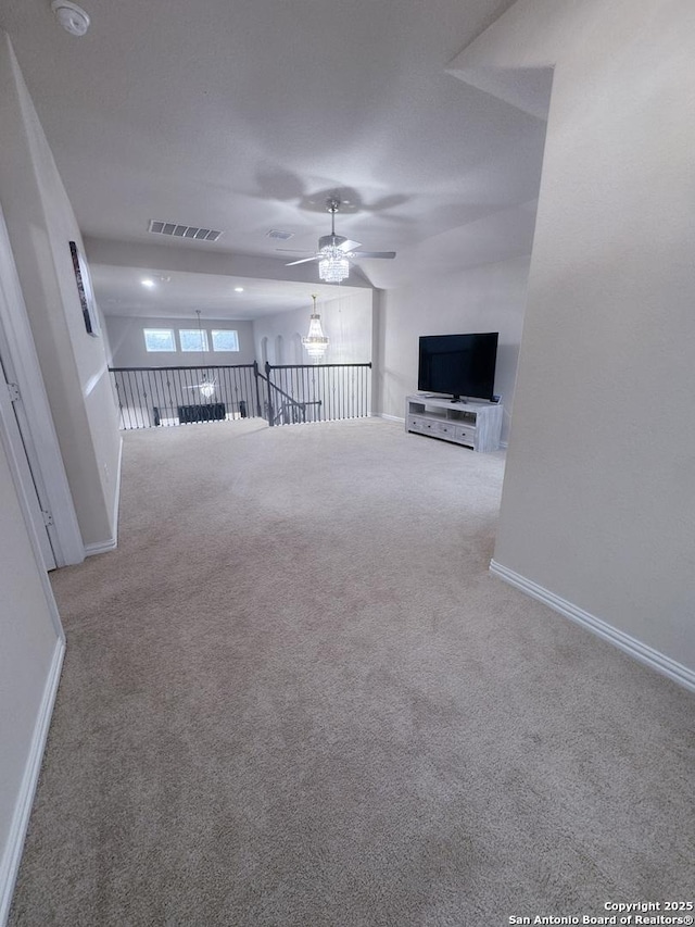 unfurnished living room with light carpet and ceiling fan