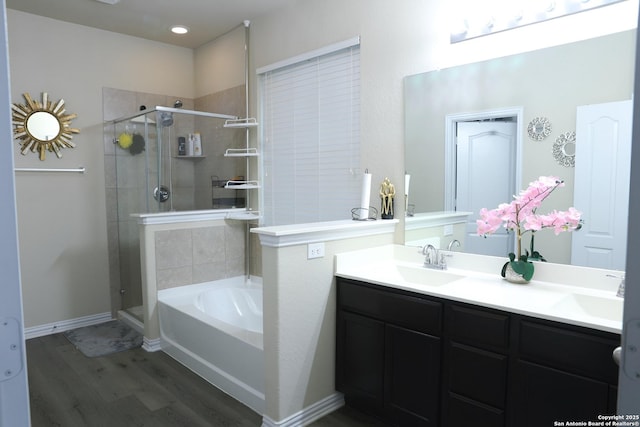 bathroom featuring vanity, separate shower and tub, and hardwood / wood-style floors