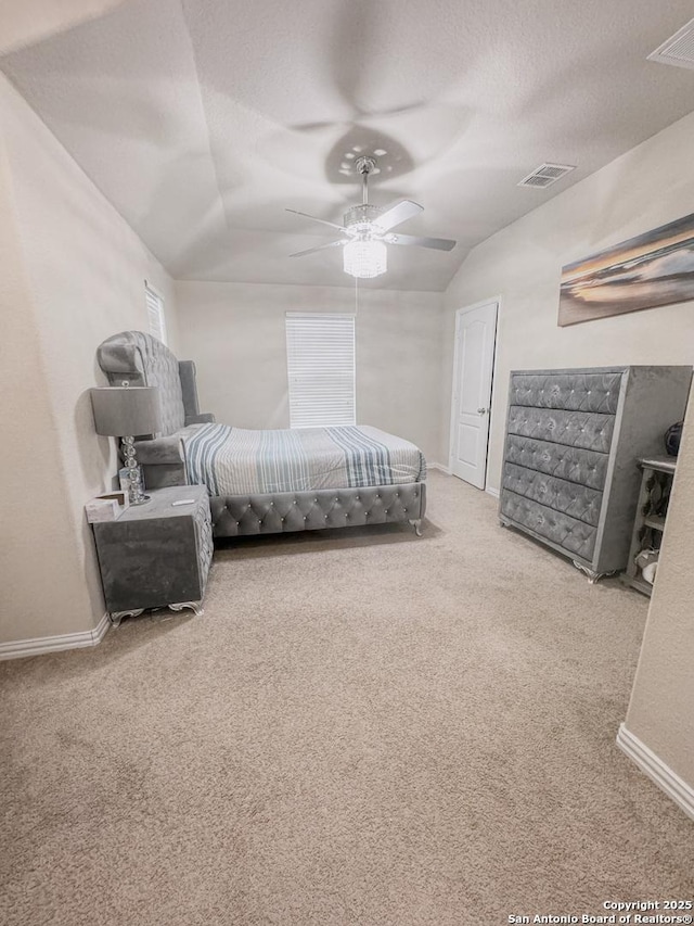 carpeted bedroom with multiple windows, ceiling fan, lofted ceiling, and a textured ceiling