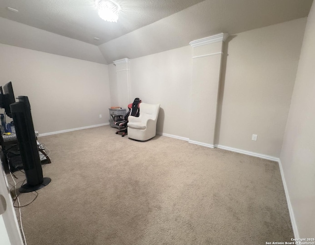 interior space featuring vaulted ceiling, carpet, and ornate columns