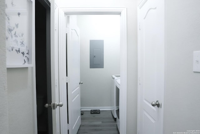 laundry area featuring dark wood-type flooring, electric panel, and independent washer and dryer