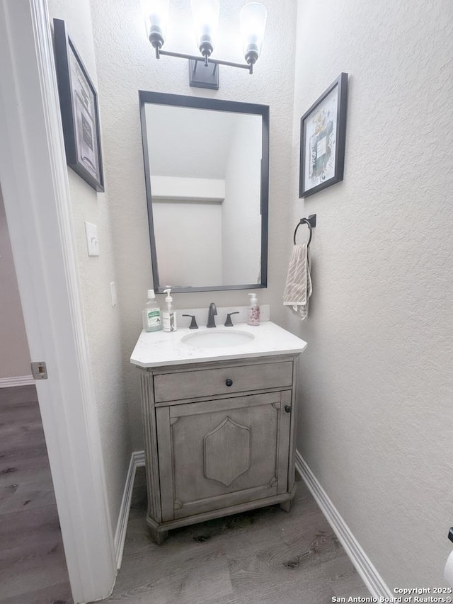 bathroom with vanity and wood-type flooring