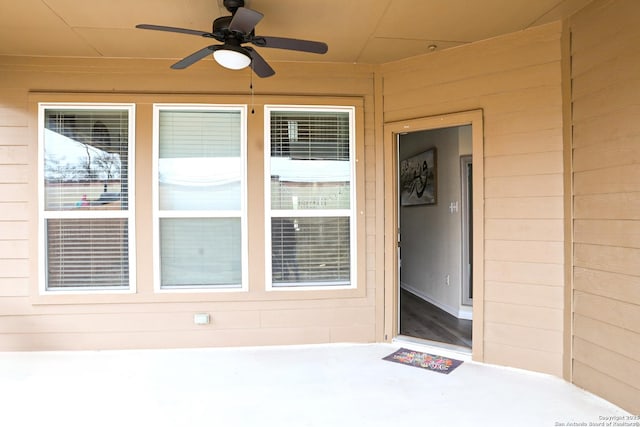 view of exterior entry with ceiling fan