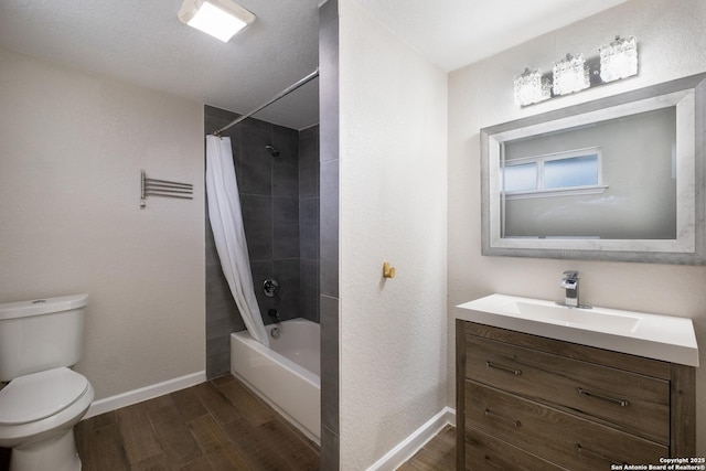 full bath featuring shower / tub combo, wood finished floors, toilet, and baseboards