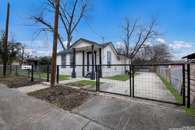 view of front facade featuring a fenced front yard and a gate